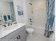 Fresh bathroom with a white tub, gray vanity, and modern fixtures with blue design elements at Lot 29 Bozeman Ct # 29, Stanley, NC 28164