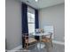 Bright sitting area featuring modern furniture, soft carpet and a large window with blue curtains at Lot 29 Bozeman Ct # 29, Stanley, NC 28164