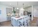 Modern kitchen with gray cabinets, stainless steel appliances, quartz countertops and island with bar stool seating at Lot 29 Bozeman Ct # 29, Stanley, NC 28164