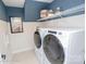 Modern laundry room featuring new, white washer and dryer and shelving with storage at Lot 29 Bozeman Ct # 29, Stanley, NC 28164