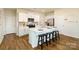 Modern kitchen featuring a quartz island with seating, stainless appliances, and hardwood floors at 1044 Horizon Ln, Chester, SC 29706