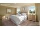 Serene bedroom filled with natural light, showcasing a plush bed, neutral tones, and coordinated decor at 1044 Horizon Ln, Chester, SC 29706