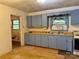 View of kitchen with blue cabinetry and window view at 112 Greenwood Ave, Belmont, NC 28012
