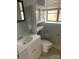 Bathroom with white vanity, toilet, and a window providing natural light at 1121 Myrtle Ave # 58, Charlotte, NC 28203