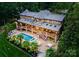 Gorgeous backyard showcasing a stunning pool, tiered patios, and lush landscaping on a private lot at 116 Creeky Hollow Dr, Mooresville, NC 28117