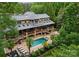 Aerial view of a beautifully designed backyard with pool, patio, lounge area and expansive deck at 116 Creeky Hollow Dr, Mooresville, NC 28117