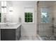 Modern bathroom featuring a glass shower with tiled walls, vanity, stylish fixtures and bright natural light at 116 Creeky Hollow Dr, Mooresville, NC 28117