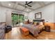 Comfortable bedroom with coffered ceiling, access to private balcony and warm decor at 116 Creeky Hollow Dr, Mooresville, NC 28117