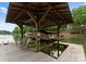 Covered boat lift on a lake with seating, providing waterfront property access at 116 Creeky Hollow Dr, Mooresville, NC 28117