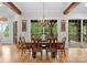 Beautiful dining room featuring wood floors, beamed ceilings, a chandelier, and a view of the outdoors at 116 Creeky Hollow Dr, Mooresville, NC 28117