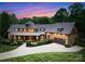 Stunning two-story home featuring manicured landscaping, gray roof, and an attached garage with a concrete driveway at 116 Creeky Hollow Dr, Mooresville, NC 28117