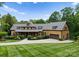 Beautifully landscaped front yard showcasing a two-story home with a welcoming entrance and attached garage at 116 Creeky Hollow Dr, Mooresville, NC 28117