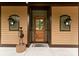 Charming front entrance featuring a wooden door, decorative lights, and unique accent pieces at 116 Creeky Hollow Dr, Mooresville, NC 28117