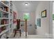 Bright hallway features a built-in bookcase, interesting artwork and a stairway leading to the next level at 116 Creeky Hollow Dr, Mooresville, NC 28117