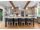 Gourmet kitchen featuring a large island with seating, custom cabinetry, and high-end appliances at 116 Creeky Hollow Dr, Mooresville, NC 28117