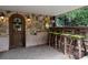 Covered outdoor bar area with stone walls, barstools, and wrought iron accents at 116 Creeky Hollow Dr, Mooresville, NC 28117