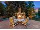 Outdoor stone fireplace on a patio with seating area for backyard relaxation at 116 Creeky Hollow Dr, Mooresville, NC 28117