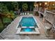 Inviting pool and spa surrounded by a stone patio, lounge chairs, and lush landscaping, creating a tranquil oasis at 116 Creeky Hollow Dr, Mooresville, NC 28117