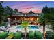 Resort-style backyard features a sparkling pool, palm trees, stone patio and an expansive deck at 116 Creeky Hollow Dr, Mooresville, NC 28117