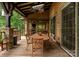 Covered deck and outdoor dining area including comfortable seating and lake views at 116 Creeky Hollow Dr, Mooresville, NC 28117