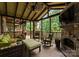 Inviting screened porch with stone fireplace, TV, and seating for enjoying the outdoors in comfort at 116 Creeky Hollow Dr, Mooresville, NC 28117