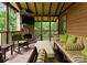 Comfortable screened porch with stone fireplace and TV, perfect for relaxation and entertainment at 116 Creeky Hollow Dr, Mooresville, NC 28117