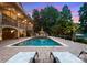Backyard swimming pool and spa area with an outdoor living space and landscaped surroundings at 116 Creeky Hollow Dr, Mooresville, NC 28117