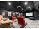 A stylish theater room is furnished with comfortable seating, a projector, and a large viewing screen at 116 Creeky Hollow Dr, Mooresville, NC 28117