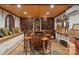 Elaborate wine cellar with custom racking, stone walls, seating, and tasting area at 116 Creeky Hollow Dr, Mooresville, NC 28117