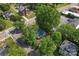 Aerial view of the home and its neighborhood, surrounded by lush trees at 118 Cabarrus W Ave, Concord, NC 28025