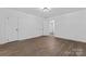 Spacious bedroom with new floors and two doors leading to other areas of the home at 118 Cabarrus W Ave, Concord, NC 28025