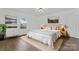 Bright bedroom with new floors, neutral colors, artwork and a large window at 118 Cabarrus W Ave, Concord, NC 28025