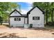 Charming two-story house with black framed windows, leafy trees, and grey painted siding at 118 Cabarrus W Ave, Concord, NC 28025