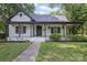 Charming home featuring a covered front porch, fresh landscaping, and light exterior at 118 Cabarrus W Ave, Concord, NC 28025