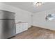 Bright kitchen featuring stainless steel appliances, granite countertops, and new flooring at 118 Cabarrus W Ave, Concord, NC 28025