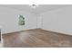 Bright living room featuring wood flooring, a large window, and fresh paint at 118 Cabarrus W Ave, Concord, NC 28025