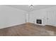 Cozy living room featuring a fireplace, wood flooring, and ample natural light at 118 Cabarrus W Ave, Concord, NC 28025
