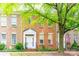 Charming brick townhome featuring a classic design with a well-manicured front yard and mature tree at 123 Singleton Rd, Mooresville, NC 28117