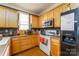 Well-lit kitchen featuring wooden cabinets, modern appliances, and ample counter space at 123 Singleton Rd, Mooresville, NC 28117