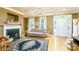 Comfortable living room with a fireplace, large windows, and hardwood floors, perfect for relaxation at 123 Singleton Rd, Mooresville, NC 28117