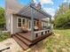Inviting back deck featuring egg chairs, wooden pergola with string lights, and outdoor grill at 15313 Moate Ct, Huntersville, NC 28078
