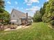 Wide shot of backyard featuring a stone patio, fire pit, and a spacious deck for outdoor relaxation at 15313 Moate Ct, Huntersville, NC 28078