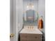 Stylish half bath with decorative mirror, modern lighting, and elegant vanity at 15313 Moate Ct, Huntersville, NC 28078