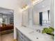 Bathroom with dual vanities, decorative mirrors, and access to main bedroom at 15313 Moate Ct, Huntersville, NC 28078