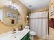 Stylish bathroom featuring vanity, updated lighting, round mirror, and shower-tub combo at 15313 Moate Ct, Huntersville, NC 28078