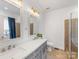 Spacious bathroom featuring double sinks, tiled shower, and contemporary fixtures at 15313 Moate Ct, Huntersville, NC 28078
