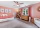 Charming bedroom featuring pink walls, a window, and a twin bed with built-in storage underneath at 15313 Moate Ct, Huntersville, NC 28078