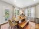 Dining room features a wood table, a bench, chairs, and lots of natural light from three windows at 15313 Moate Ct, Huntersville, NC 28078
