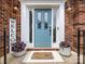 Close-up of the home's front door, showing its blue color, sidelights, and decorative welcome sign at 15313 Moate Ct, Huntersville, NC 28078