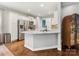 Spacious kitchen with white cabinets, granite countertops, an island, and stainless steel appliances at 15313 Moate Ct, Huntersville, NC 28078